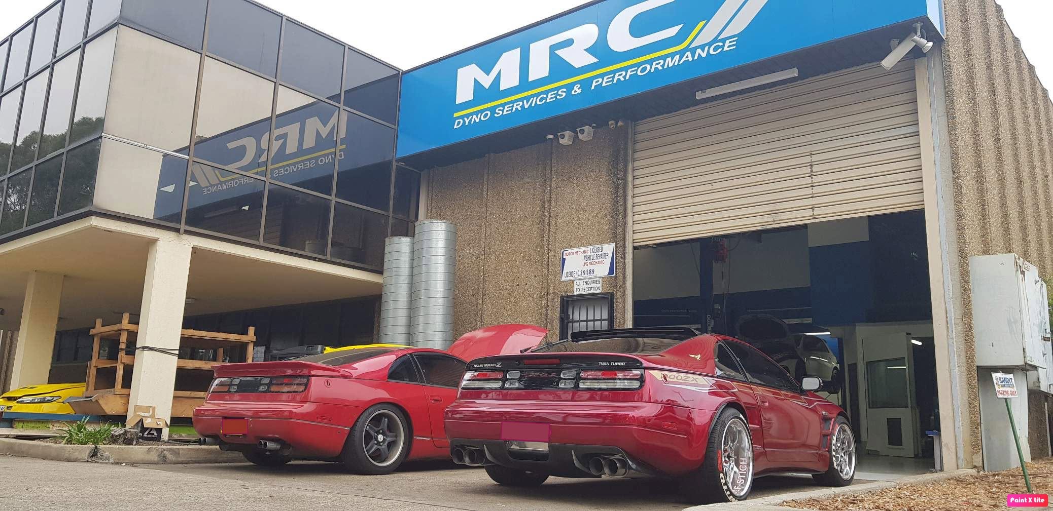 Two red Nissan 300ZX Twin Turbos parked outside the MRC Dyno Services & Performance workshop in Seven Hills